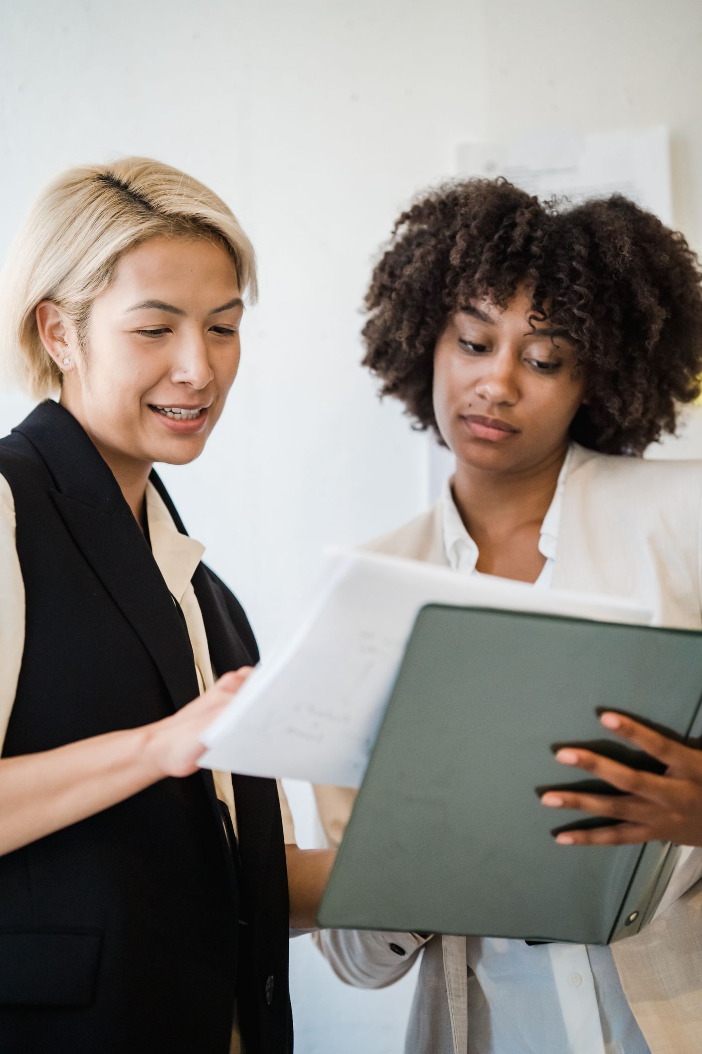 Two women discussing documents during a consultation