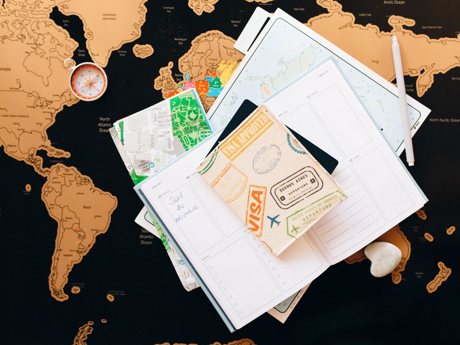 Organized travel documents and route planning materials on a map